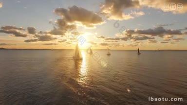 航拍的游艇与帆在海上与美丽的日落景观游艇在开阔的海上